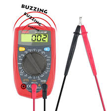 Working on the internals of a pinball machine with a multimeter