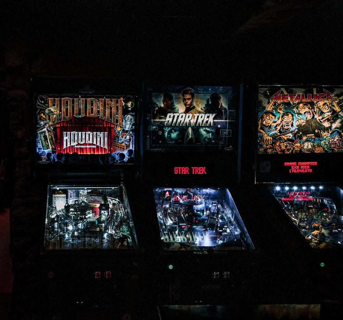 Row of pinball machines lined up on the floor of an expo — Pinball Expo 2026, Chicago
